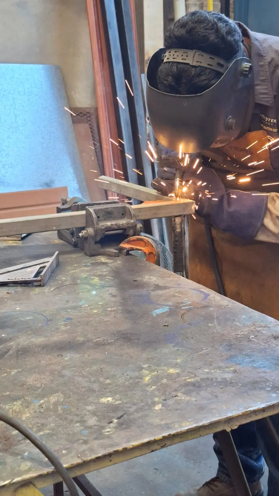 Welding the cart frame with sparks — industrial welding