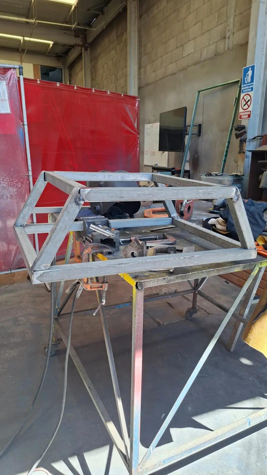 Frame assembly with tacked vertical supports being checked