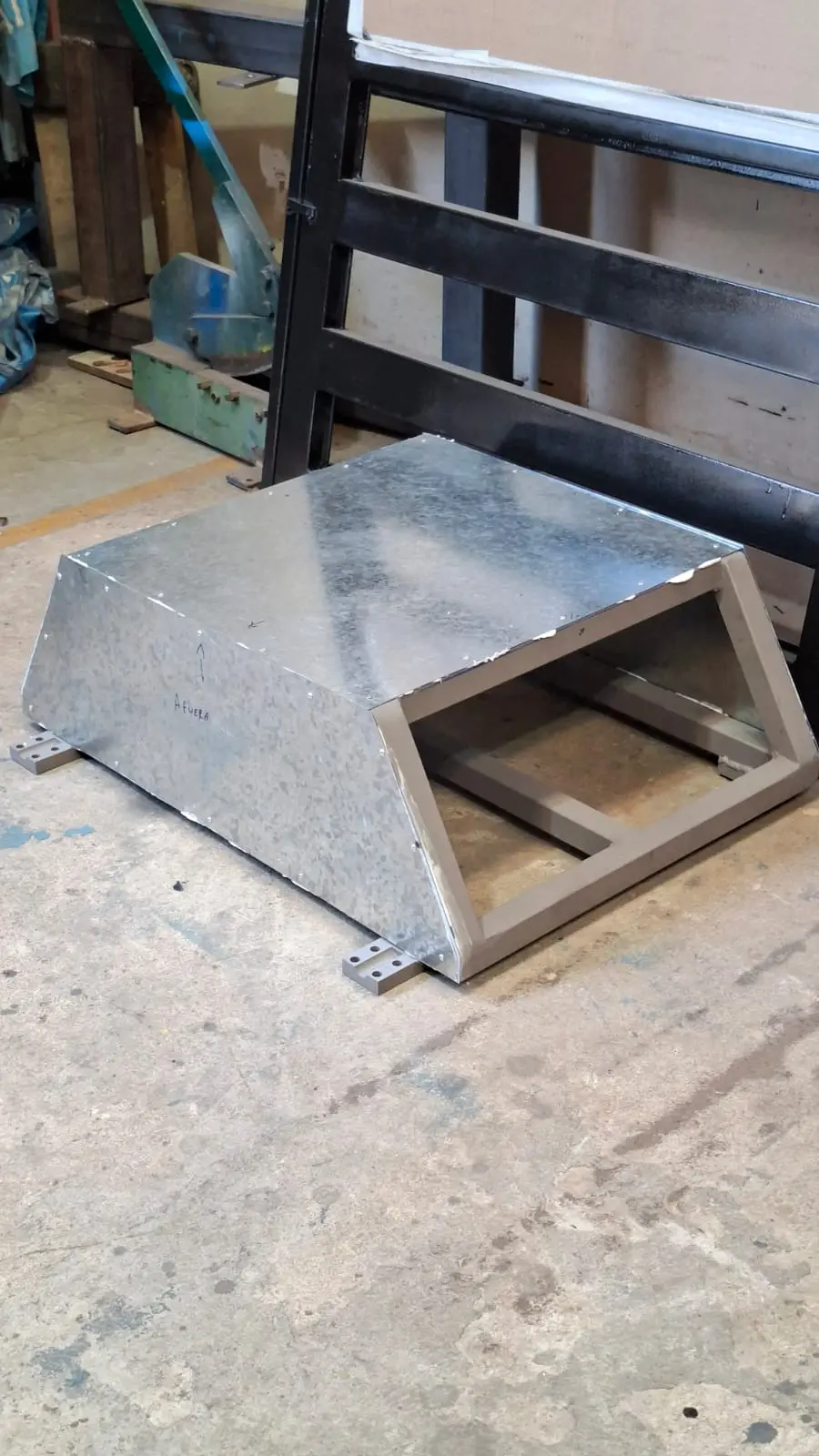 Cladding the frame with galvanized sheet and machined base plates